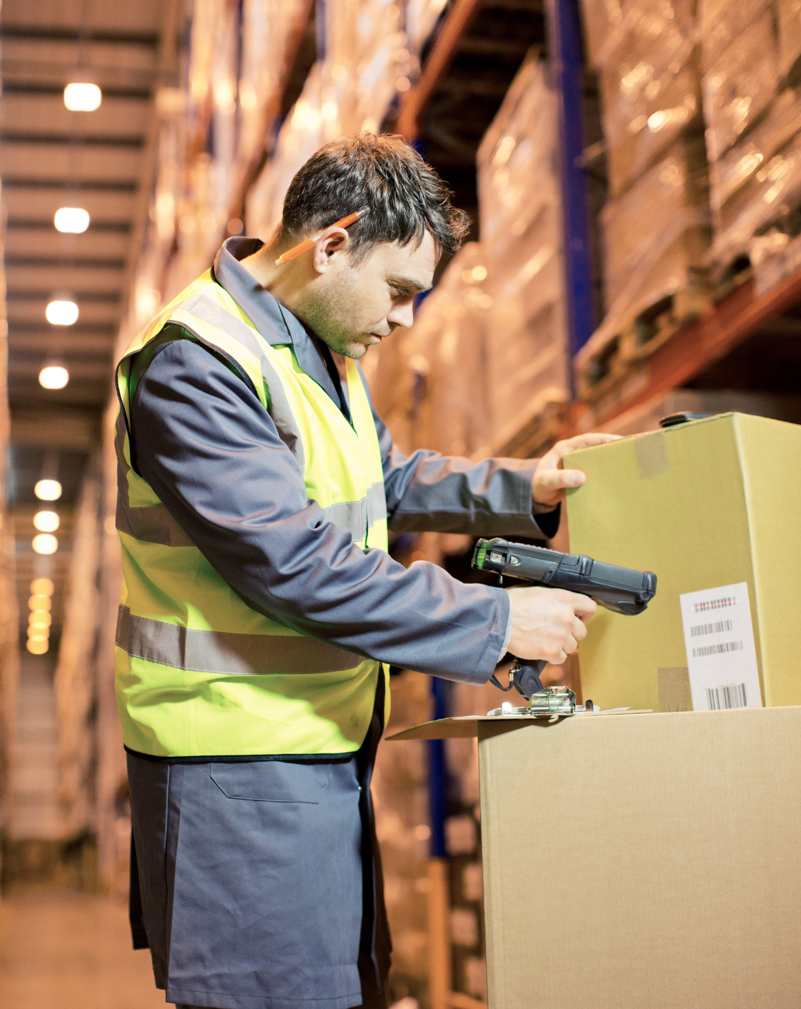 man in warehouse scanning box