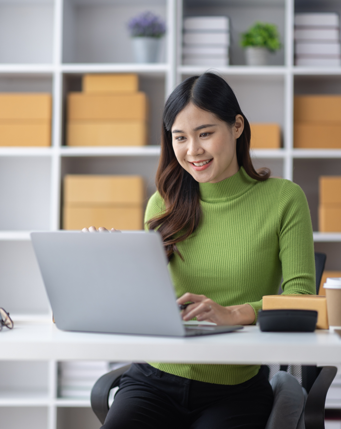 woman smiling typing on laptop