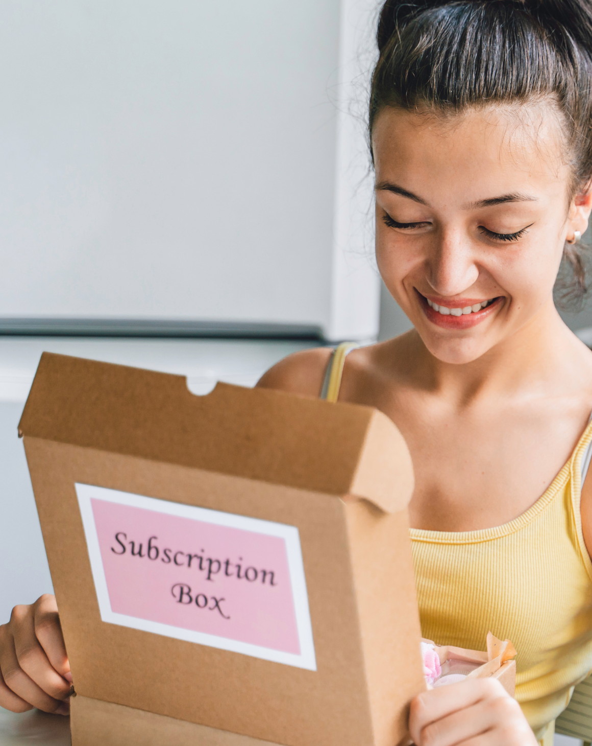 A girl holding a subscription box from a CPG brand