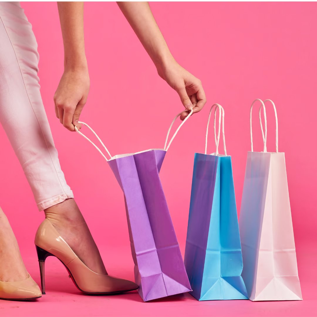A woman looking at paper shopping bags