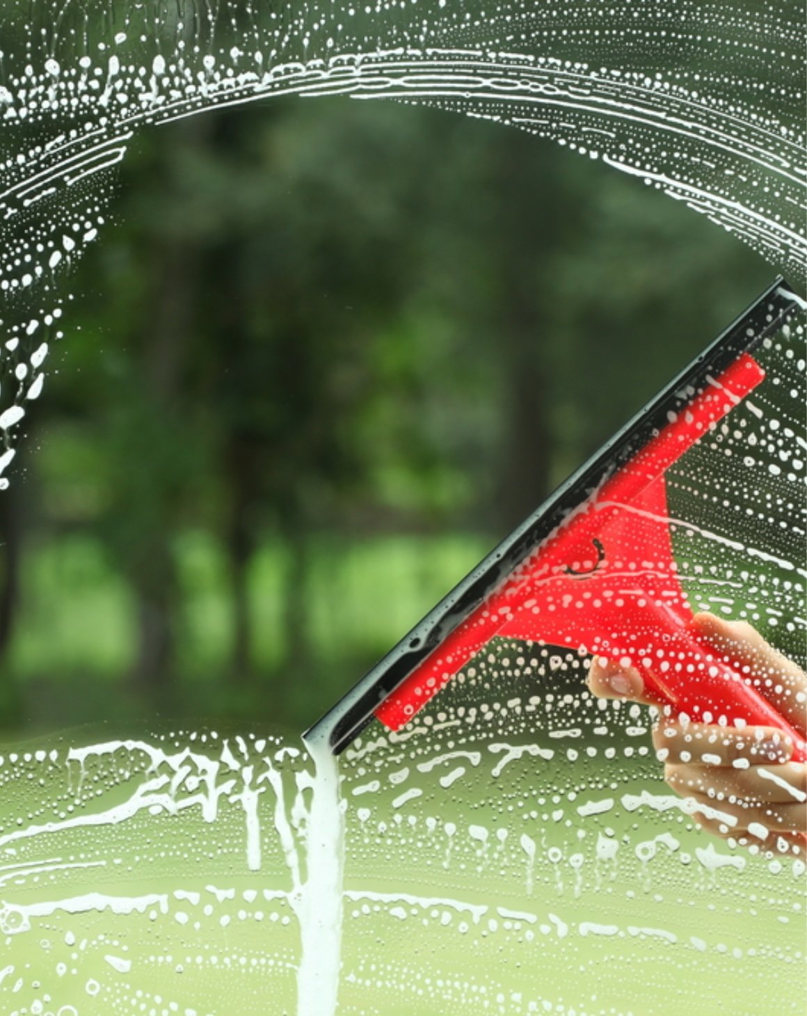 window getting cleaned with squeegee
