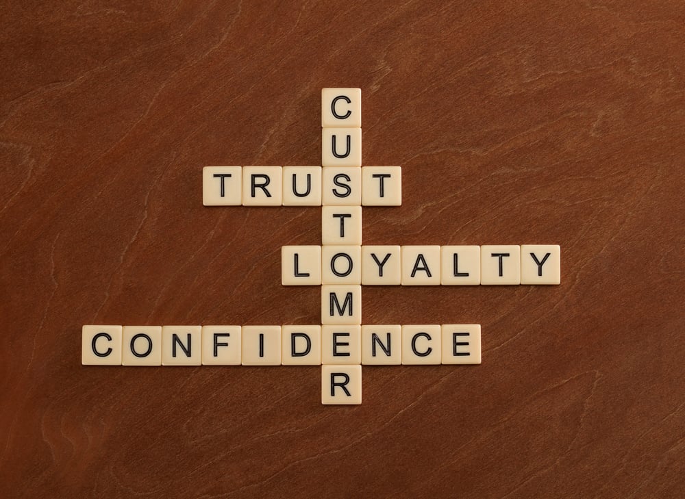 scrabble letters spelling out customer, trust, loyalty, confidence